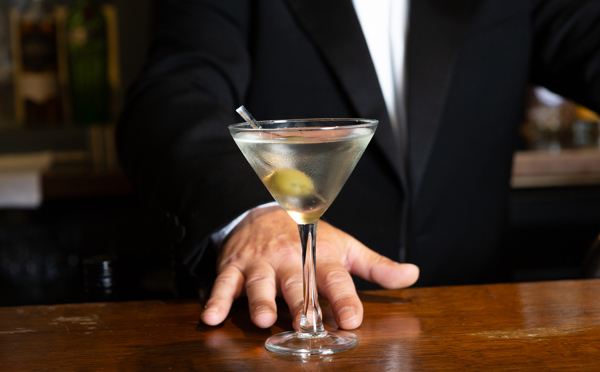 Waiter serving a martini
