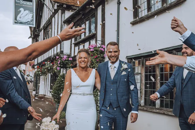 throwing confetti over bride and groom - Lottie Photography