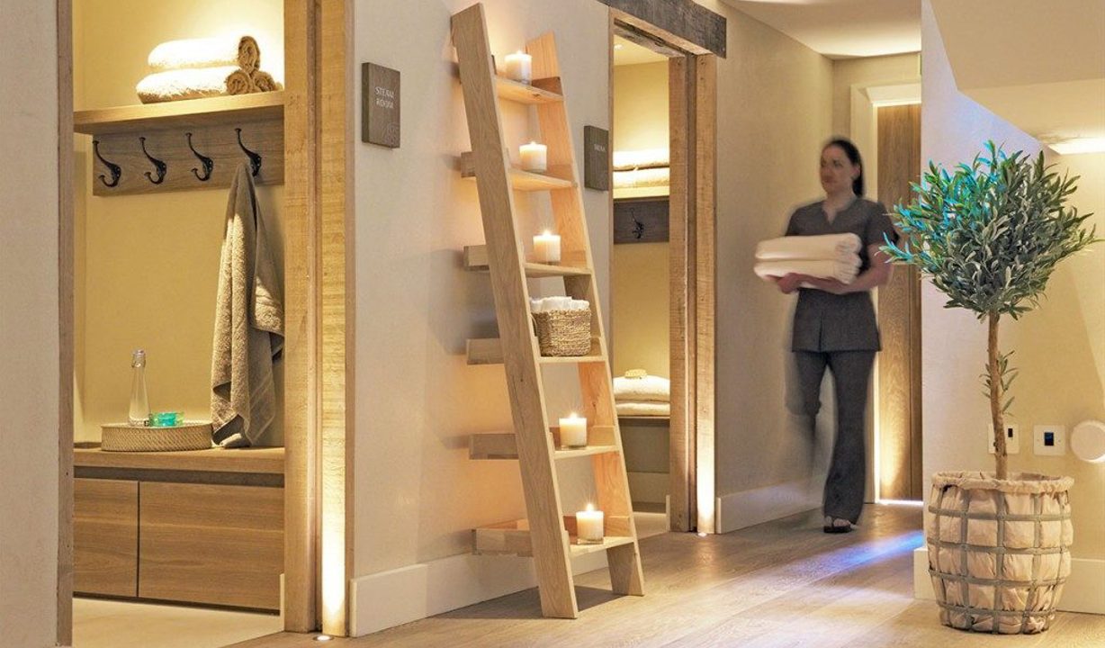 The Swan at Lavenham Hotel & Spa - Weavers' House Spa female therapist carrying towels