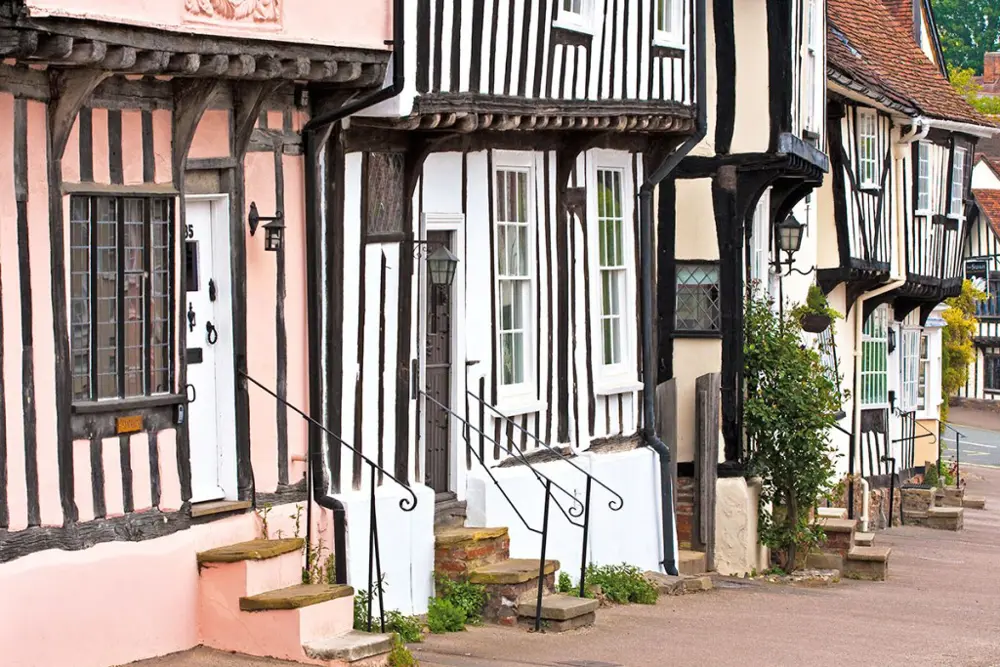 Lavenham High Street. Suffolk pink was traditionally made by mixing limewash with whatever was to hand, sloe juice or ox blood among them, which is why no two houses on the street are quite the same shade.