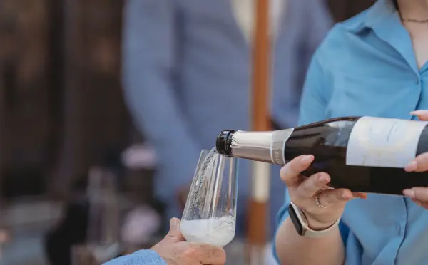 Pouring prosecco into flute glass