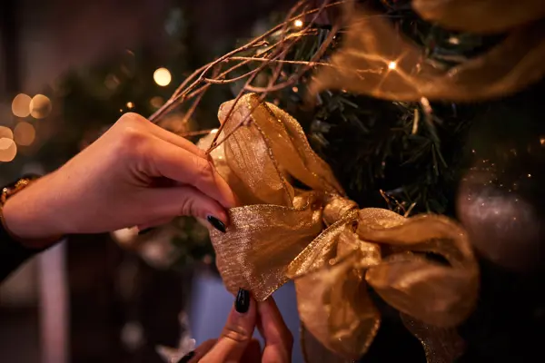 Putting a decoration on the tree