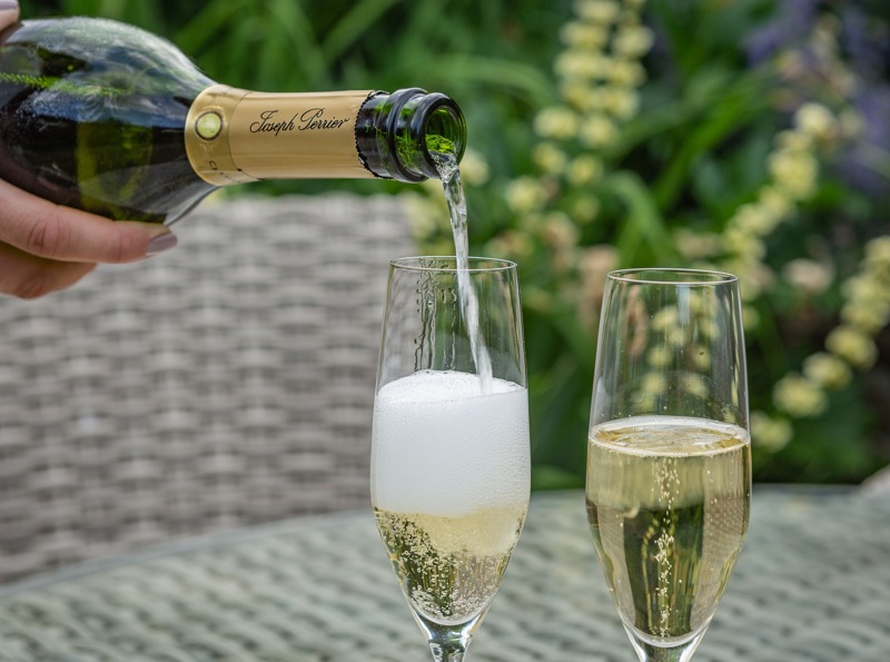 The Swan at Lavenham, pouring of Champagne in the garden