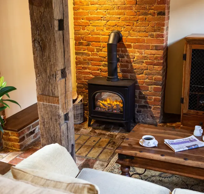 The Priory Suite Lavenham, lounge with log burner and coffee table
