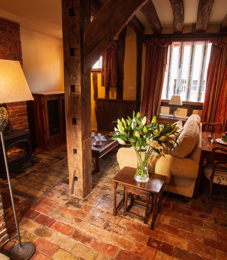 The Priory Suite Lavenham, lounge with sofa, lamp and flowers