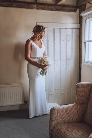 Bride ready in her dress with bouquet - Lottie Photography