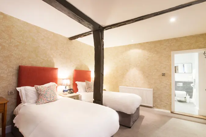 Twin room with oak beam separating the beds