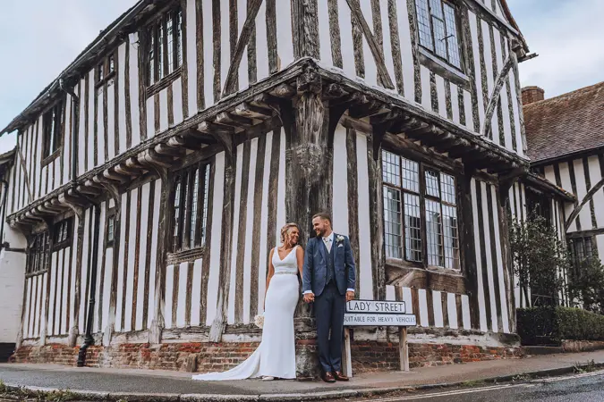 Couple standing on corner of Woolhall - Lottie Photography